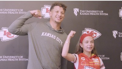 Make-A-Wish kid Myka and Patrick Mahomes flex their muscles for the camera.