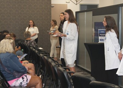 Tareen Dermatology providers hosting an engaging medical trivia challenge for event attendees.