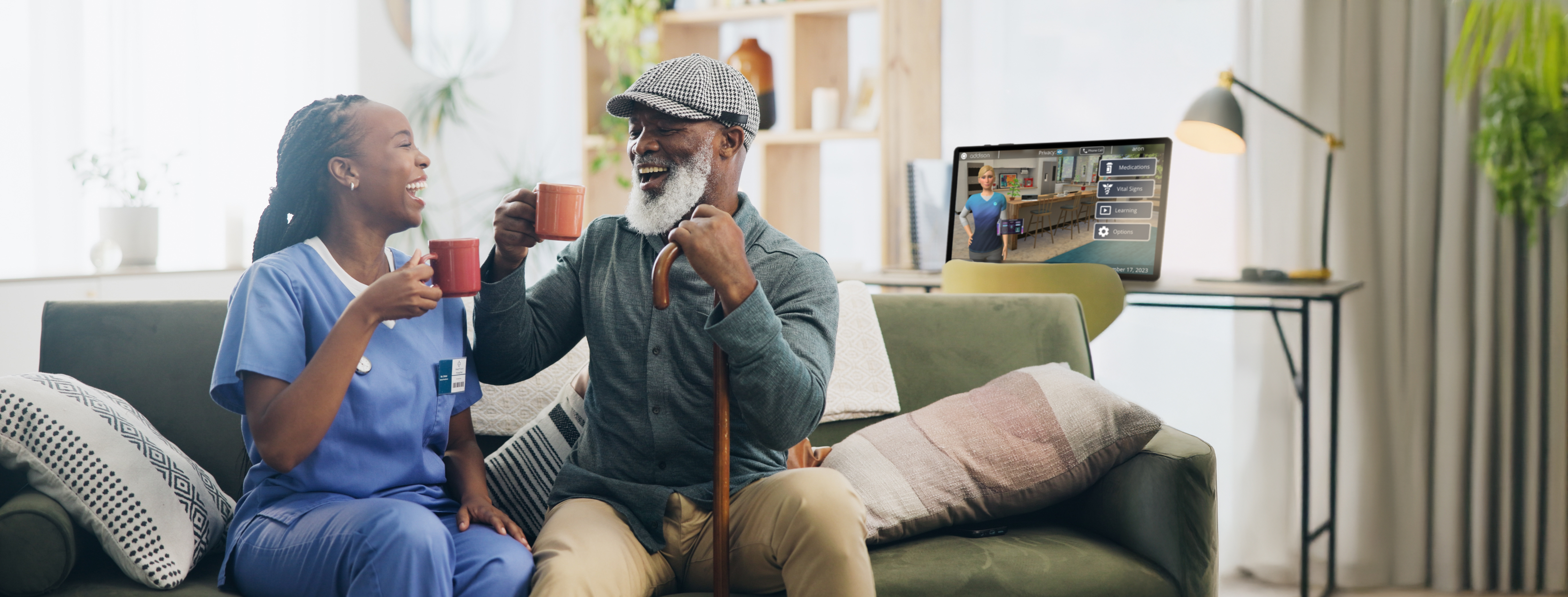Senior and Caregiver with Addison Tablet in background