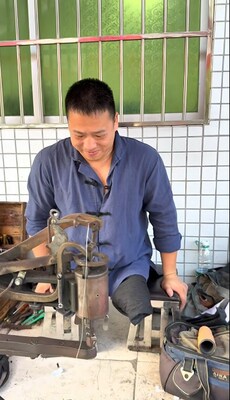Quan in front of his shoe repair stall