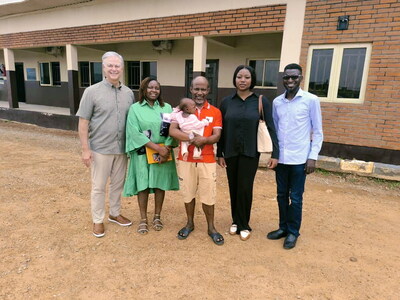 Bruce Graham, President of Both Ends Believing, with a reunited family.