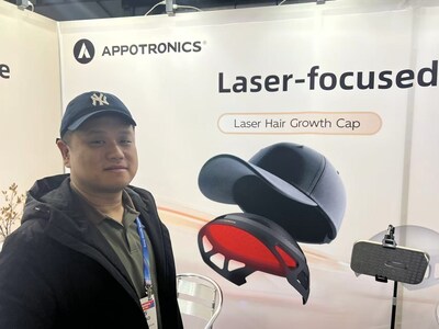 [Chen Menghao models an Appotronics "Laser Hair Growth Cap" - discretely but stylishly inserted within a baseball cap.]